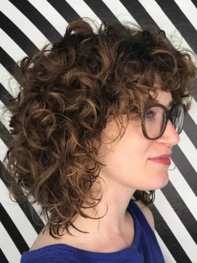cropped-1-mid-length-curly-hairstyle-with-bangs.webp